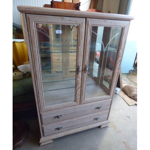 35 - LIMED OAK EFFECT DISPLAY CABINET WITH 2 GLAZED PANEL DOORS OPENING TO GLASS SHELVED INTERIOR OVER 2 ... 