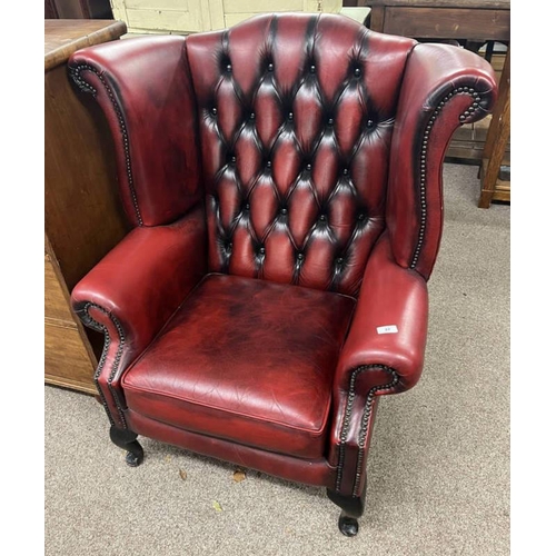 37 - RED LEATHERETTE BUTTONBACK WING BACK ARMCHAIR ON SHORT CABRIOLE SUPPORTS - 105CM TALL