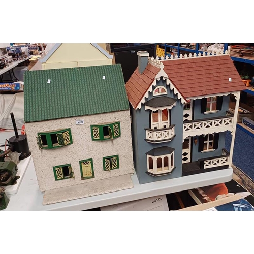 4010 - FOUR WOODEN DOLLS HOUSES. TALLEST 62CM