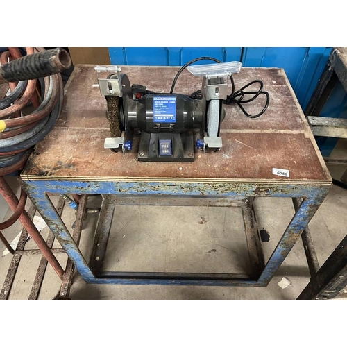 6056 - ENERGER BENCH GRINDER ON METAL AND WOOD TABLE