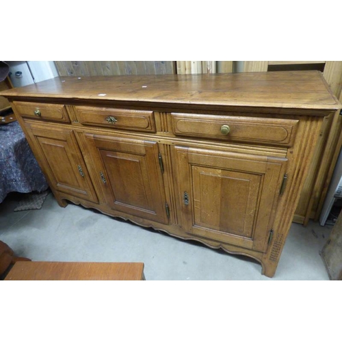 94 - OAK SIDEBOARD WITH 3 DRAWERS OVER 3 PANEL DOORS.  107 CM TALL X 188 CM WIDE