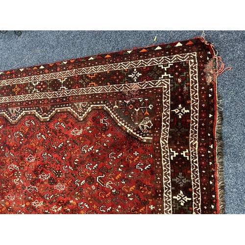 1553 - LARGE RED GROUND MIDDLE EASTERN CARPET BY THE PERSIAN RUG COMPANY, 250 X 360 CM