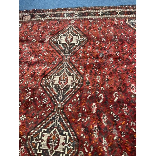 1553 - LARGE RED GROUND MIDDLE EASTERN CARPET BY THE PERSIAN RUG COMPANY, 250 X 360 CM