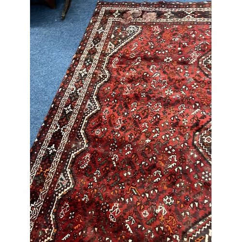 1553 - LARGE RED GROUND MIDDLE EASTERN CARPET BY THE PERSIAN RUG COMPANY, 250 X 360 CM