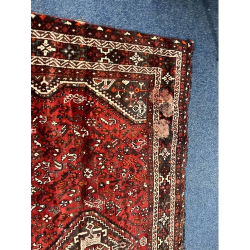 1553 - LARGE RED GROUND MIDDLE EASTERN CARPET BY THE PERSIAN RUG COMPANY, 250 X 360 CM