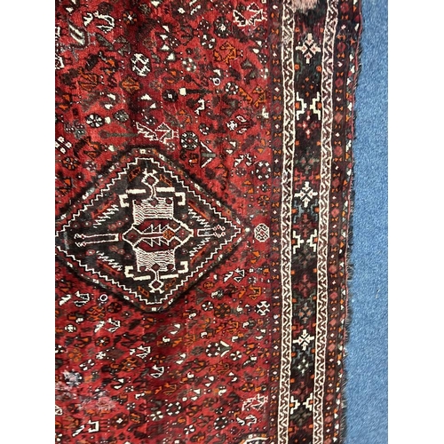 1553 - LARGE RED GROUND MIDDLE EASTERN CARPET BY THE PERSIAN RUG COMPANY, 250 X 360 CM