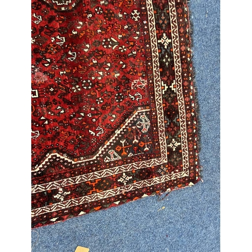 1553 - LARGE RED GROUND MIDDLE EASTERN CARPET BY THE PERSIAN RUG COMPANY, 250 X 360 CM