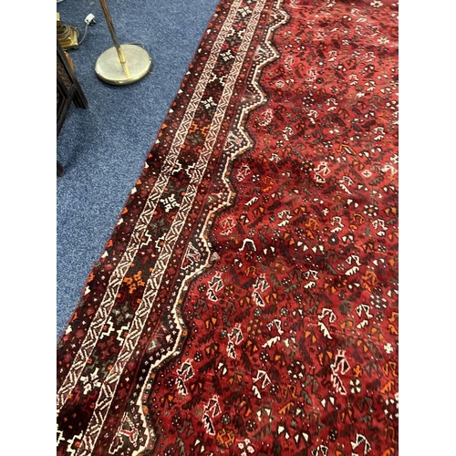 1553 - LARGE RED GROUND MIDDLE EASTERN CARPET BY THE PERSIAN RUG COMPANY, 250 X 360 CM