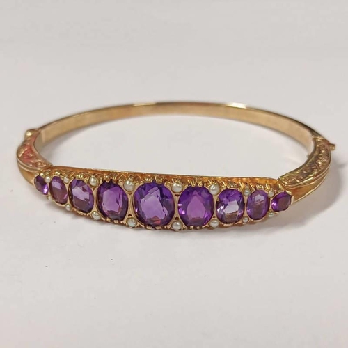 135 - 9CT GOLD PEARL & AMETHYST BANGLE WITH OVAL & ROUND CUT AMETHYSTS & SEED PEARL ACCENTS - 5.7CM INNER ... 