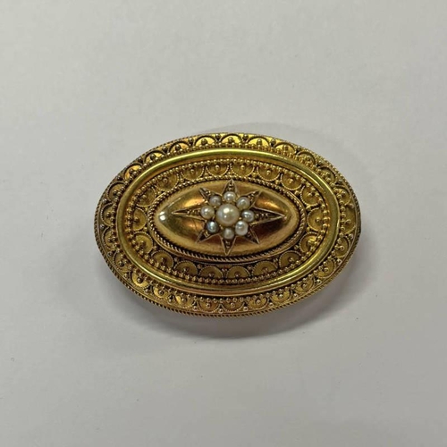 150 - 19TH CENTURY GOLD OVAL BROOCH WITH PEARL STARBURST DECORATION - 4.5 CM WIDE