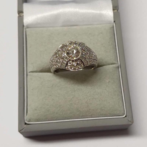 177 - 18K GOLD DIAMOND SET RING, THE PRINCIPAL DIAMOND APPROX 0.55 CARATS SET WITHIN A DIAMOND SET MOUNT B... 