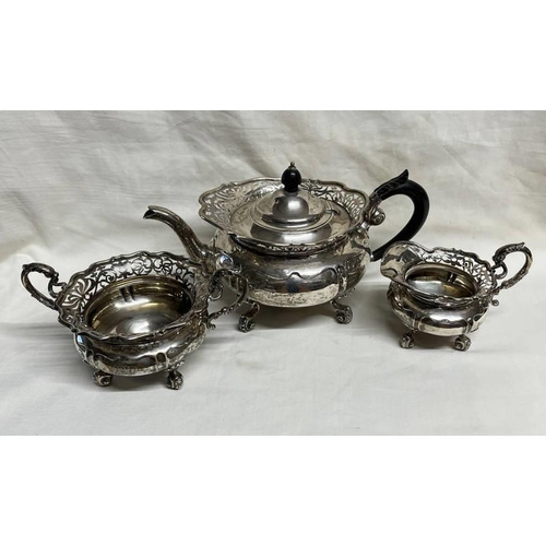 199 - SILVER 3 PIECE TEASET WITH PIERCED DECORATION ON SCROLL SUPPORTS BY GOLDSMITHS & SILVERSMITHS CO LON... 