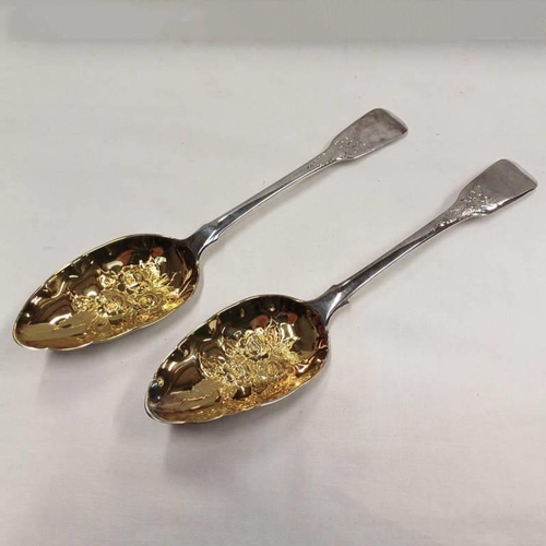 27 - PAIR OF GEORGE III SILVER BERRY TABLESPOONS WITH GILDED FOLIATE EMBOSSED BOWLS, LONDON 1814 - 140G