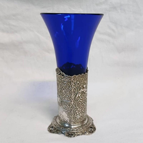 271 - VICTORIAN SILVER & BLUE GLASS TAPERING VASE DECORATED WITH CHERUBS & MUSICAL INSTRUMENTS WITH IMPORT... 