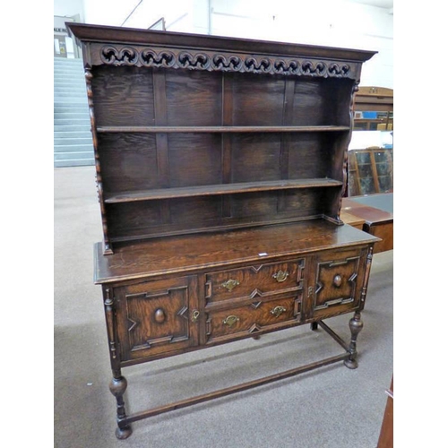 5057 - EARLY 20TH CENTURY OAK WELSH DRESSER WITH SHELF BACK OVER BASE OF 2 CENTRAL DRAWERS FLANKED BY 2 PAN... 