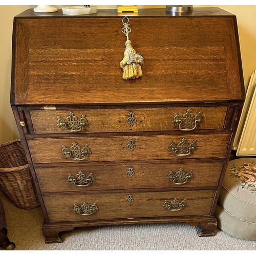 5065 - 19TH CENTURY OAK BUREAU WITH FALL FRONT OVER 4 DRAWERS ON BRACKET SUPPORTS.  105 CM TALL