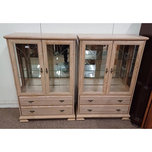 5080 - PAIR OF LIMED OAK EFFECT DISPLAY CABINETS WITH 2 GLAZED PANEL DOORS OVER 2 DRAWERS.