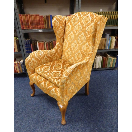 5172 - OVERSTUFFED WINGBACK ARMCHAIR WITH CREAM & GOLD PATTERN ON OAK QUEEN ANNE SUPPORTS.