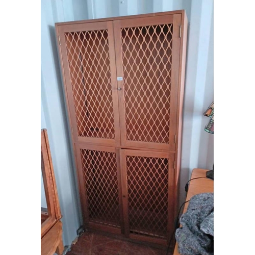 5439 - TEAK BOOKCASE WITH 4 PANEL DOORS WITH DECORATIVE METAL FRET WORK OPENING TO SHELVED INTERIOR .  190 ... 