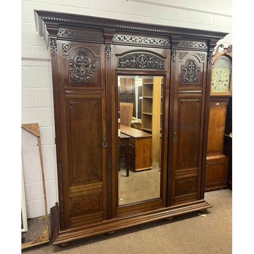 39 - 19TH CENTURY MAHOGANY TRIPLE DOOR WARDROBE WITH CENTRALLY SET MIRROR FLANKED BY 2 CARVED PANEL DOORS... 