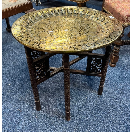 93 - MIDDLE EASTERN STYLE BRASS TRAY TABLE WITH EMBOSSED DECORATION & FOLDING HARDWOOD STAND.  DIAMETER 5... 