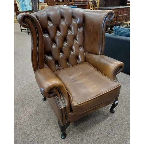 5303 - BROWN LEATHER BUTTONED WINGBACK ARMCHAIR ON SHORT QUEEN ANNE SUPPORTS LABELLED 'WINCHESTER FURNITURE... 