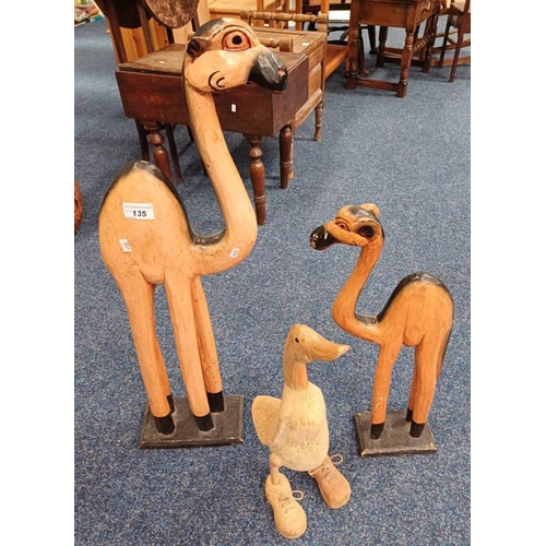135 - 2 CARVED WOODEN CAMELS AND CARVED WOODEN DUCK