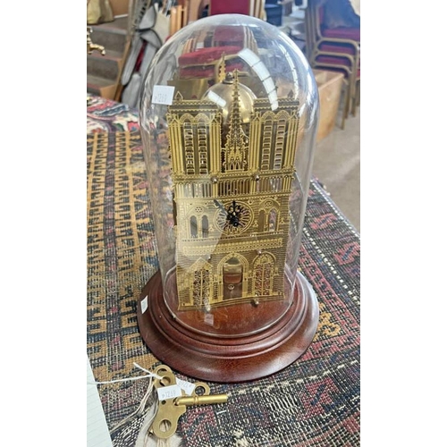 1446 - GILT METAL MANTLE CLOCK IN THE FORM OF A BUILDING WITH PIERCED FEATURES TO BOTH SIDES IN A GLASS DOM... 