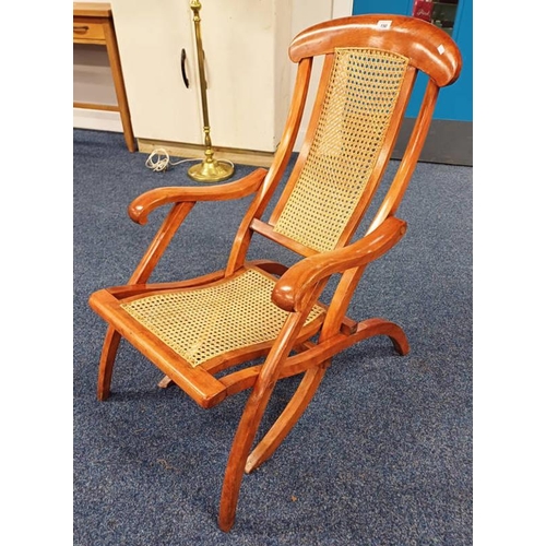 150 - EARLY 20TH CENTURY MAHOGANY FRAMED FOLDING STEAMER ARMCHAIR WITH BERGERE PANEL BACK & SEAT