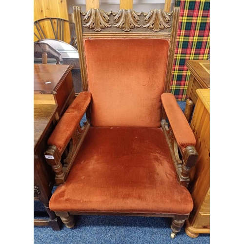 152 - OAK FRAMED GENTLEMEN'S ARMCHAIR WITH CARVED DECORATION ON TURNED SUPPORTS.