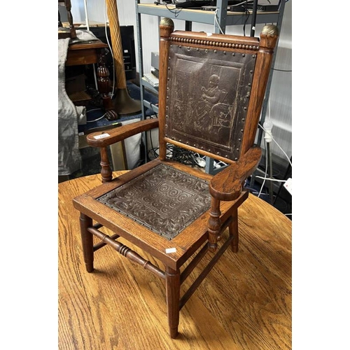 170 - OAK FRAMED CHILD'S ARMCHAIR WITH EMBOSSED LEATHER PANEL BACK & SEAT WITH CLASSICAL SCENE DECORATION