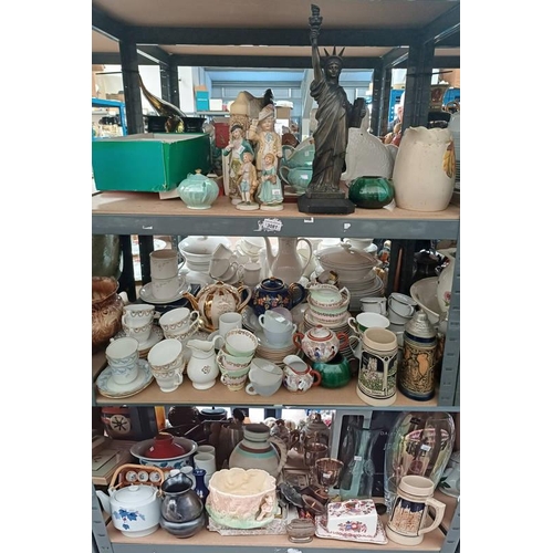 3081 - CLARICE CLIFF JUG, METAL STATUE OF LIBERTY & VARIOUS OTHER PORCELAIN TEAWARE, ETC OVER 3 SHELVES