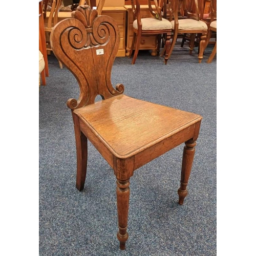 31 - 19TH CENTURY OAK HALL CHAIR WITH DECORATIVE CARVED BACK ON TURNED SUPPORTS
