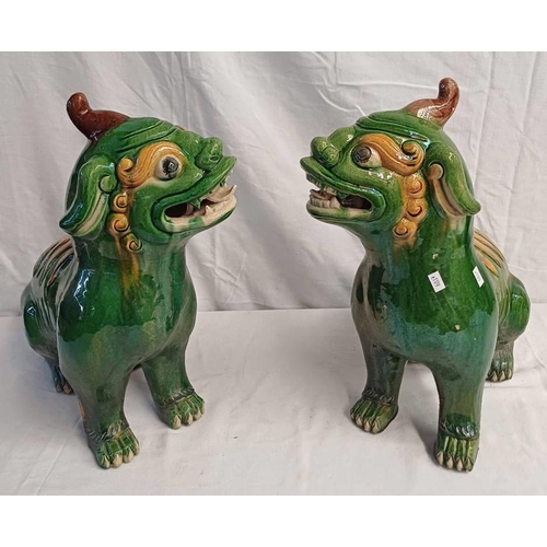 3171 - PAIR OF GREEN & YELLOW GLAZED POTTERY CHINESE DOGS OF FOO, 43CM TALL