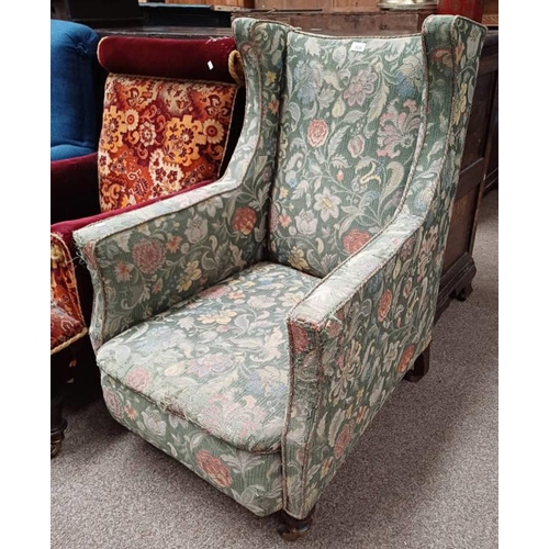 529 - 19TH CENTURY OAK FRAMED WINGBACK ARMCHAIR WITH GREEN FLORAL PATTERN