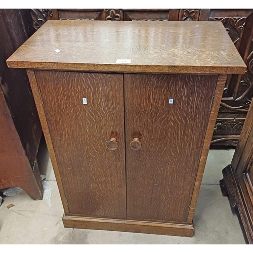 72 - 20TH CENTURY OAK CABINET WITH 2 PANEL DOORS OPENING TO SHELVED INTERIOR ON PLINTH BASE.  83 CM TALL ... 