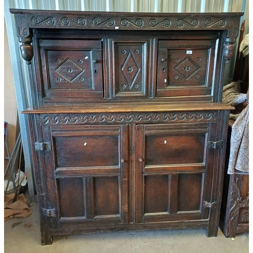 84 - CARVED OAK COURT CABINET WITH 2 PANEL DOORS OVER BASE WITH 2 PANEL DOORS & DECORATIVE FRIEZE ABOVE M... 