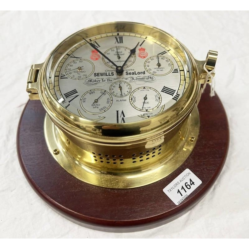 1164 - SEWILLS SEALORD BULKHEAD CLOCK, CHRONOMETER WORKS ON WOOD BASE