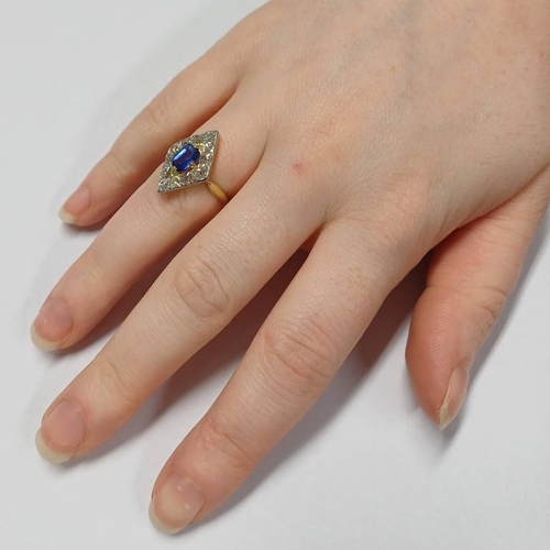 70 - SAPPHIRE & DIAMOND NAVETTE SHAPED CLUSTER RING, THE OVAL SHAPED SAPPHIRE SET WITHIN A SURROUND OF 12... 