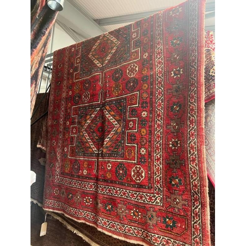 1552 - LARGE RED GROUND MIDDLE EASTERN CARPET WITH ALL OVER DESIGN AND BORDERS, 165CM X 280CM