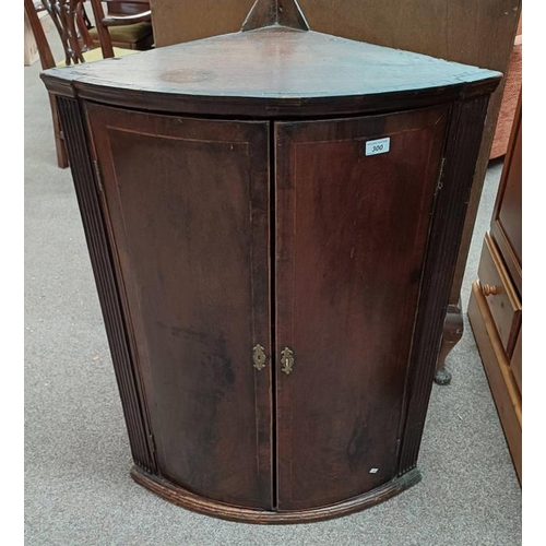 300 - 19TH CENTURY MAHOGANY BOW FRONT CORNER CABINET WITH 2 PANEL DOORS OPENING TO SHELVED INTERIOR