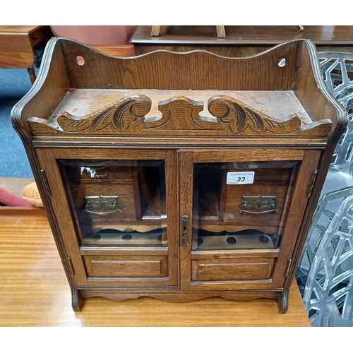 33 - LATE 19TH CENTURY OAK SMOKER'S CABINET WITH 2 GLAZED PANEL DOORS OPENING TO FITTED INTERIOR WITH 4 D... 