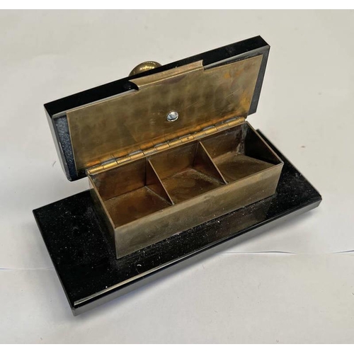 1352 - EARLY 20TH CENTURY BRASS & BLACK HARDSTONE DESKTOP STAMP HOLDER WITH FITTED INTERIOR, 13CM ACROSS