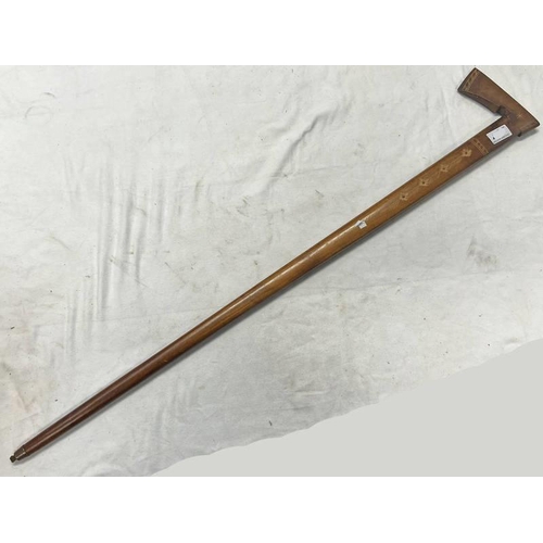 1528 - CARVED WOODEN SHEPHERDS AXE, THE 94CM LONG WOODEN BODY ETCHED WITH ROSETTES WITH A METAL TIP