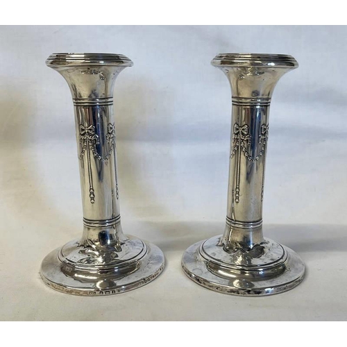17 - PAIR OF SILVER CANDLESTICKS WITH FLORAL SWAG DECORATION, BIRMINGHAM 1910 - 14CM TALL