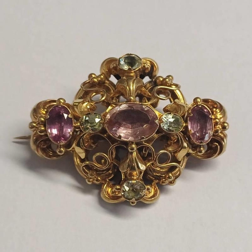 236 - 19TH CENTURY GOLD SCROLL WORK BROOCH SET WITH PINK OVAL CUT TOPAZ & CHRYSOBERYL - 4.5CM WIDE, 12.2G