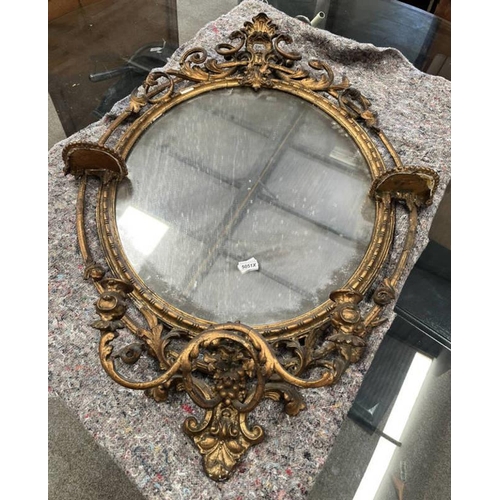 5051X - 19TH CENTURY OVAL GILT FRAMED MIRROR WITH DECORATIVE CANDLE STICKS, GLASS SIZE 70 X 60 CM
