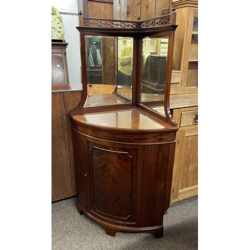 5504 - MAHOGANY BOW FRONT CORNER CABINET WITH MIRRORED TOP OVER PANELLED DOOR ON BRACKET SUPPORTS