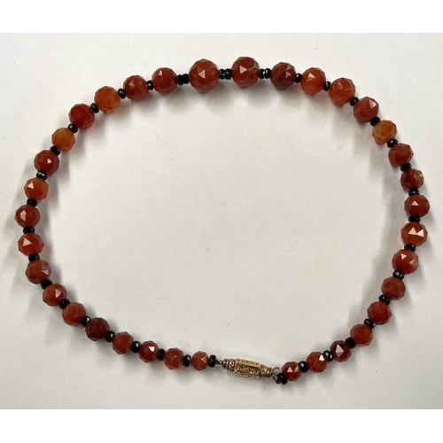 99 - FACETED CARNELIAN BEAD NECKLACE ON YELLOW METAL BARREL CLASP - 57CM LONG