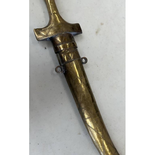 1261 - MIDDLE EASTERN JAMBIYA WITH 20.5CM LONG CURVED BLADE, WHITE METAL AND BRASS HILT AND SCABBARD